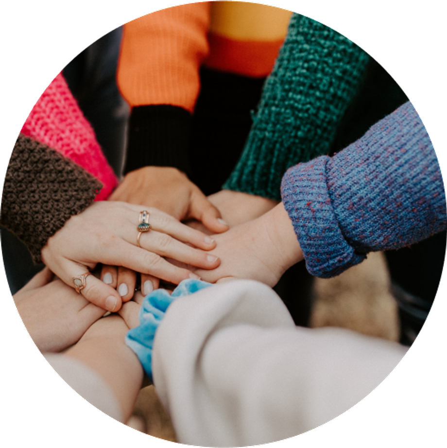 Seven people joining hands as a team